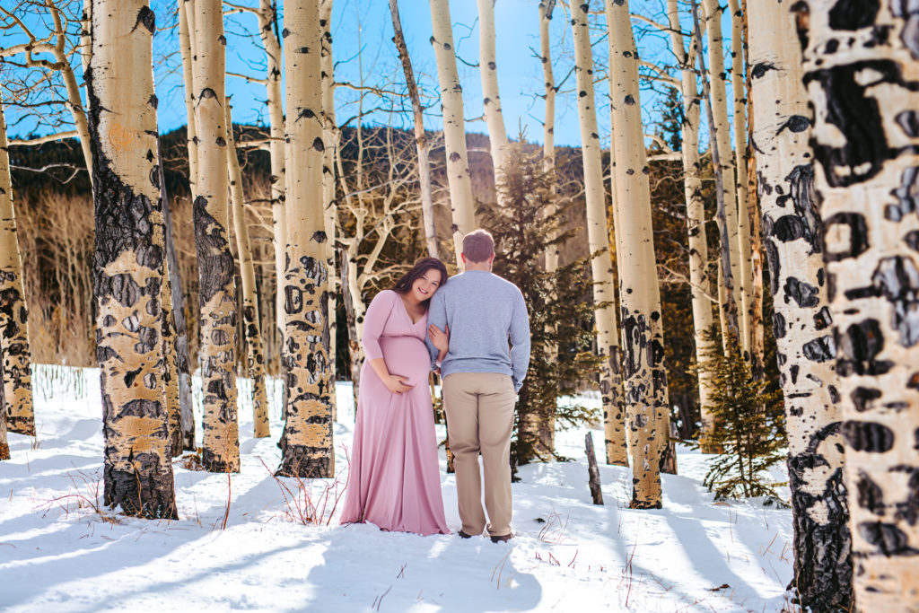 Stunning Mountain Maternity Photos among the Snowy Colorado Aspen Trees in Evergreen Colorado 