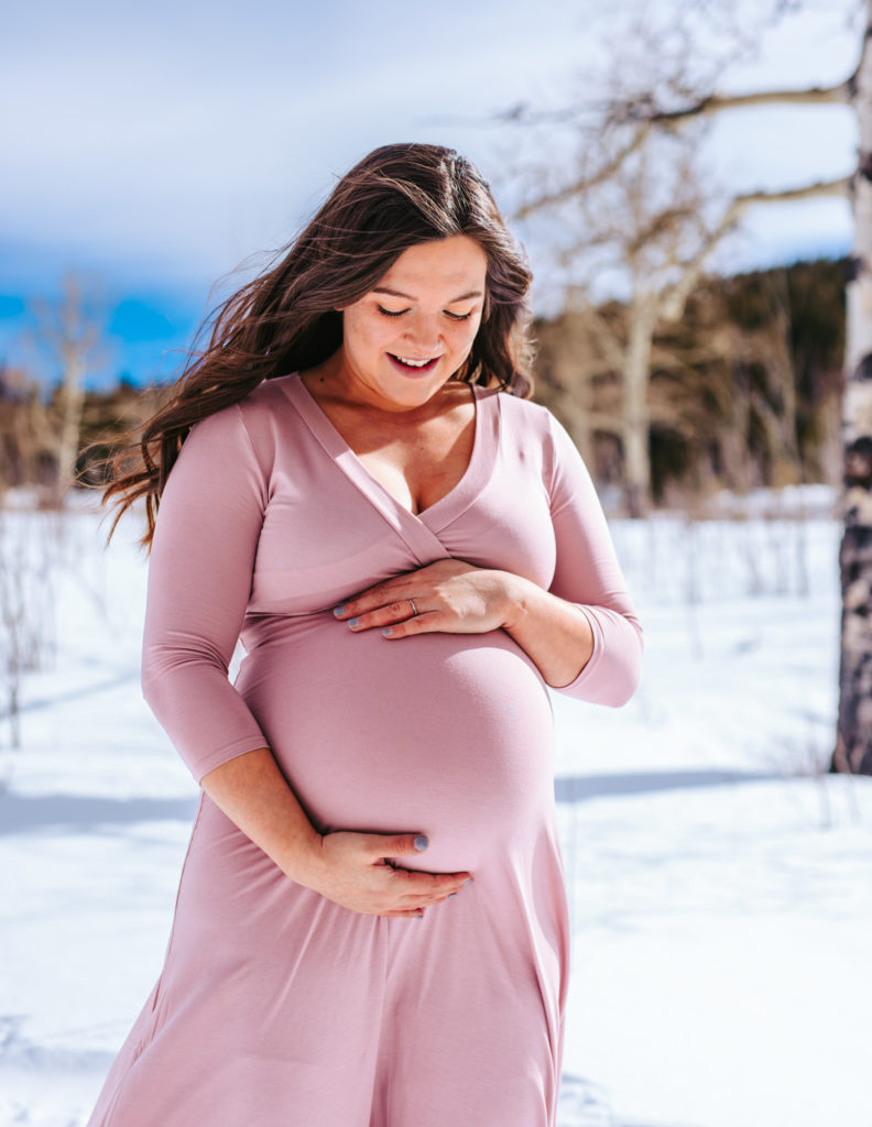 Mama to be in the mountains of colorado for a winter snowy maternity session 