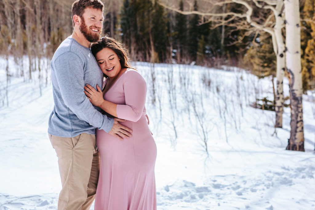 Parents to be in the snow of the mountains of Colorado 