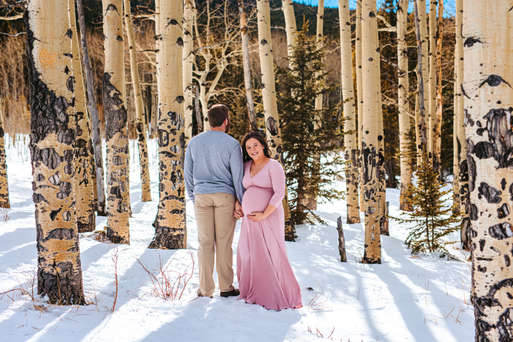 Parents to be among the aspen trees in the mountains of Colorado 