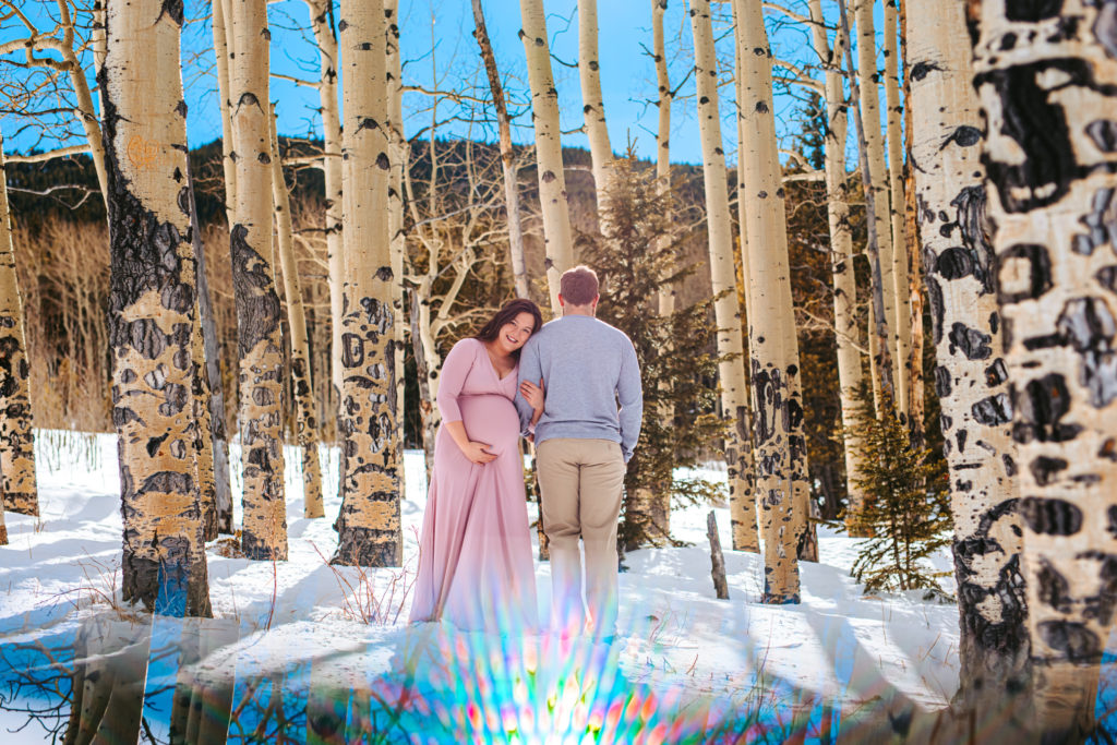 Parents to be among the aspen trees in the mountains of Colorado 