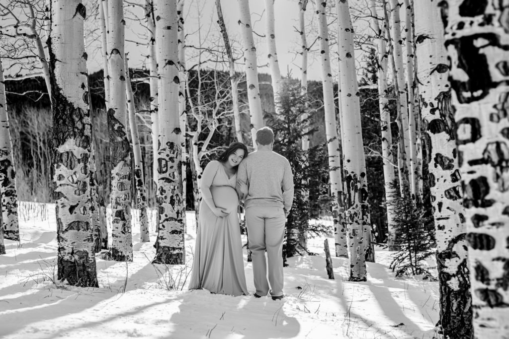 Parents to be among the aspen trees in the mountains of Colorado 