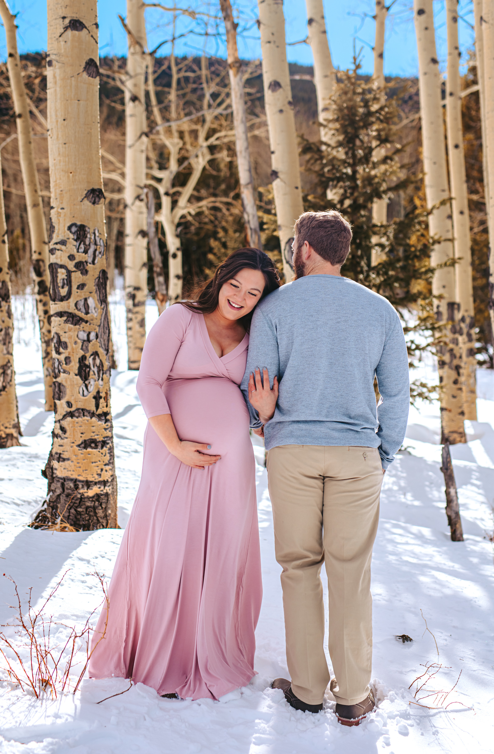 Parents to be among the aspen trees in the mountains of Colorado 