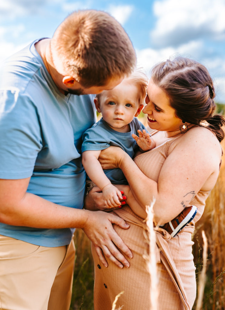 North Carolina Maternity Photographer, Stormy North Carolina Session, Maternity Photos, Maternity Photo ideas, Summer Maternity Photos, Maternity Photographer, Lifestyle Photographer, Family Maternity Photographer, North Carolina Photographer, Tall grass, Family of 3 Maternity Photos, North Carolina,