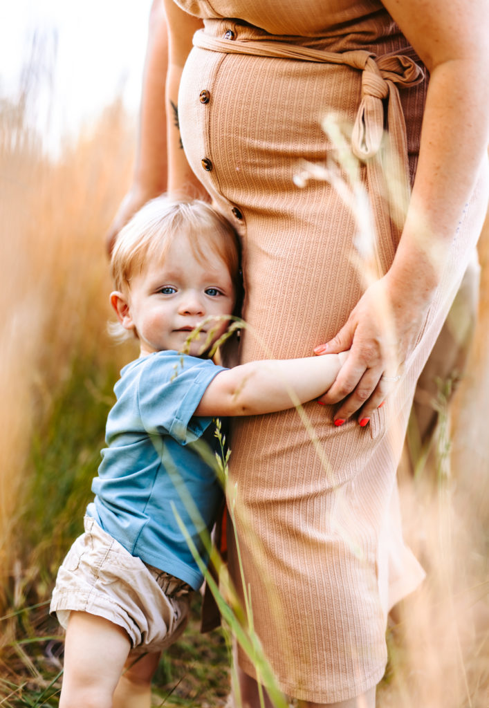 North Carolina Maternity Photographer, Stormy North Carolina Session, Maternity Photos, Maternity Photo ideas, Summer Maternity Photos, Maternity Photographer, Lifestyle Photographer, Family Maternity Photographer, North Carolina Photographer, Tall grass, Family of 3 Maternity Photos, North Carolina,