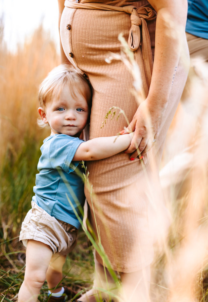 North Carolina Maternity Photographer, Stormy North Carolina Session, Maternity Photos, Maternity Photo ideas, Summer Maternity Photos, Maternity Photographer, Lifestyle Photographer, Family Maternity Photographer, North Carolina Photographer, Tall grass, Family of 3 Maternity Photos, North Carolina,