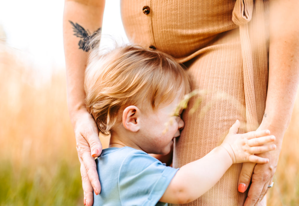 North Carolina Maternity Photographer, Stormy North Carolina Session, Maternity Photos, Maternity Photo ideas, Summer Maternity Photos, Maternity Photographer, Lifestyle Photographer, Family Maternity Photographer, North Carolina Photographer, Tall grass, Family of 3 Maternity Photos, North Carolina,