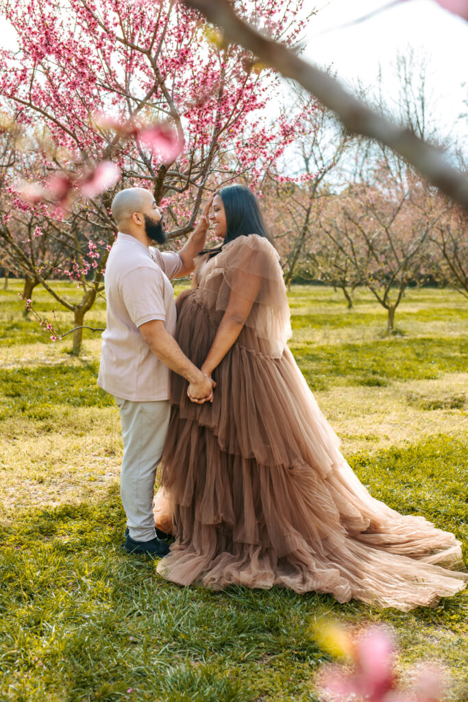 Couples Maternity Portraits amid the Peach blooms at Millstone Creek Orchard - Photo By RattTrap Artistry 