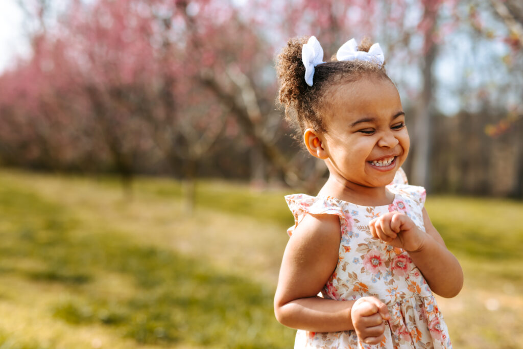 Sweet Little girl running with a pure joy smile at Millstone Creek Orchard By RattTrap Artistry 