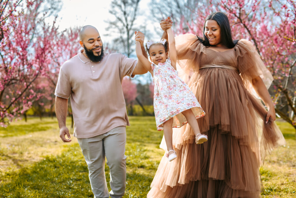 Swinging a little girl family photo at  Millstone Creek Orchard By RattTrap Artistry 