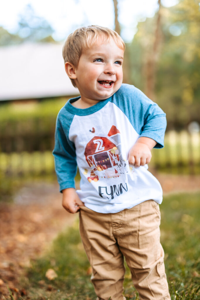 Cheesing little Two Year old boy, at home family photos session in High Points, North Carolina 