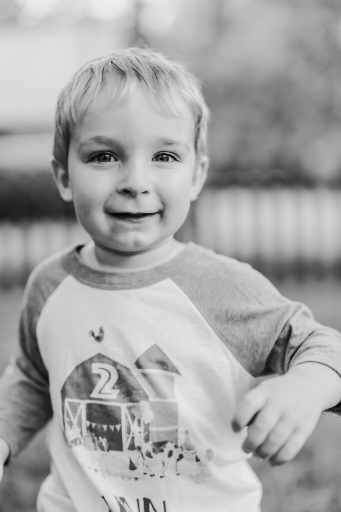 Two year old boy running at camera, at home family photos session in High Points, North Carolina 