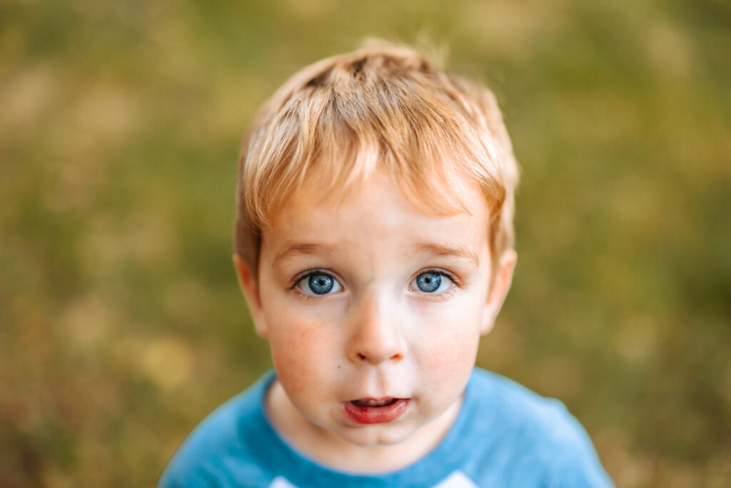 Two Year old boy with big blue eyes portrait, at home family photos session in High Points, North Carolina 