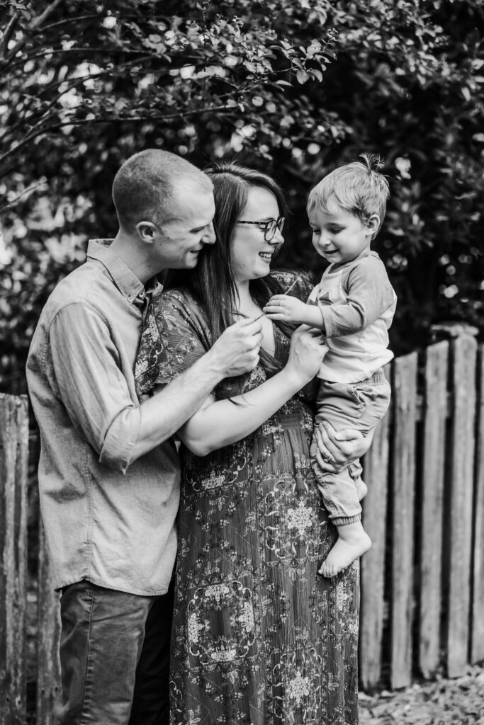 Black and white photo of a family of there, at home family photos session in High Points, North Carolina 