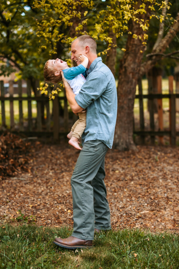 Dad tickling his son, at home family photos session in High Points, North Carolina 