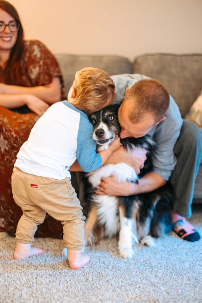 Little Boy hugging his aussie dog, durning an in home family photos session in High Points, North Carolina 