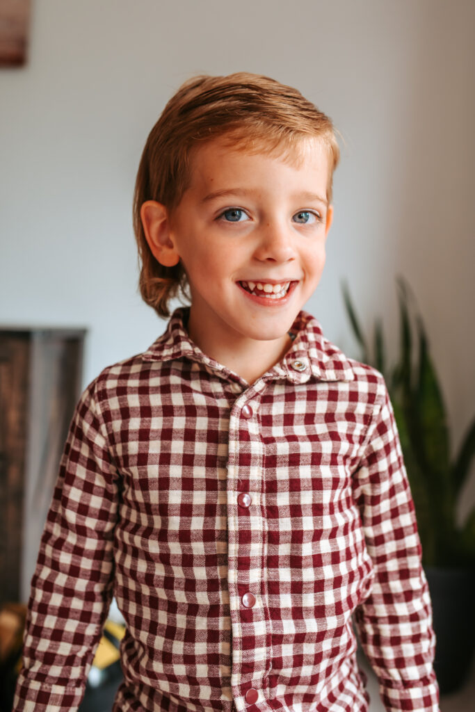 Excited big brother for photos with baby sister for their in home newborn session 