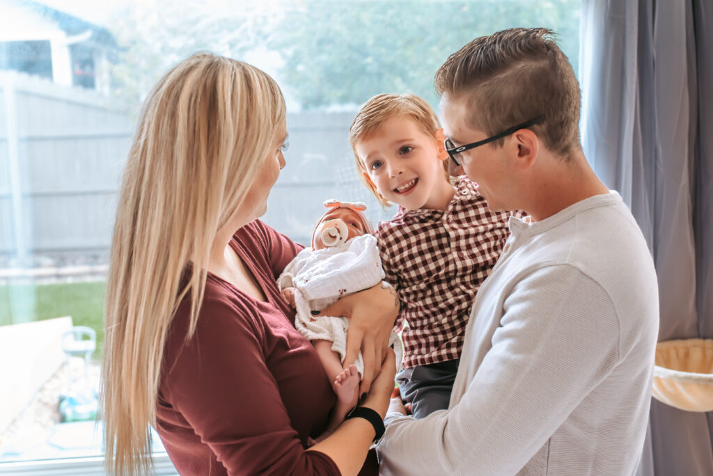 Family of four capturing their in home newborn session, from the comfort of their own home. 