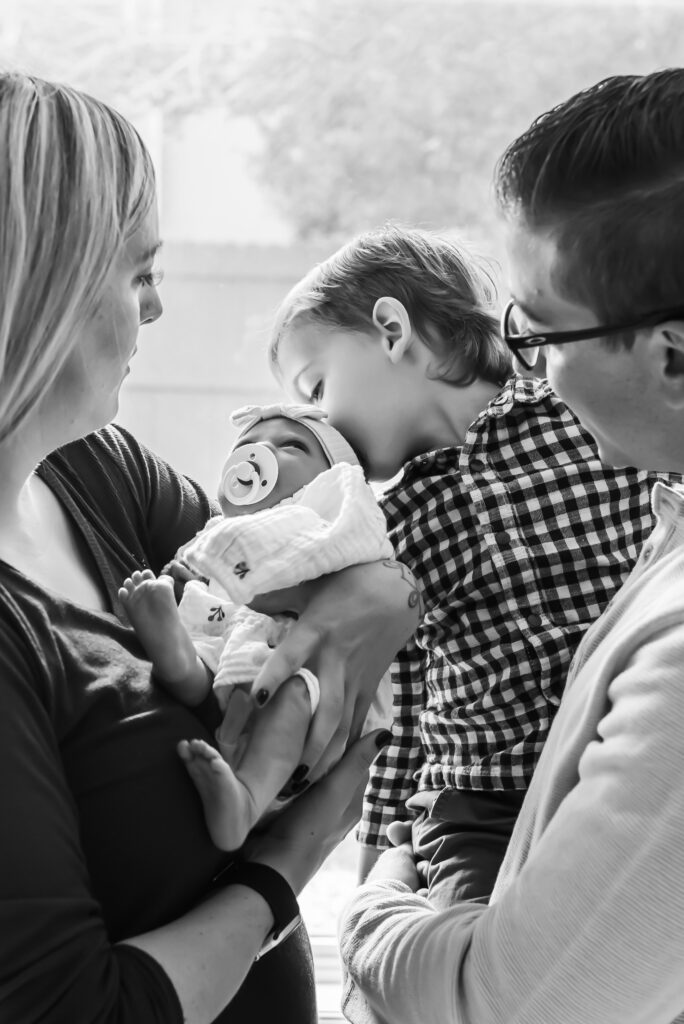 Family of four capturing their in home newborn session, from the comfort of their own home. 