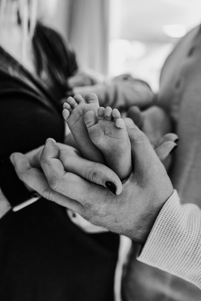 Mom and dad and baby toes at their in home newborn session 