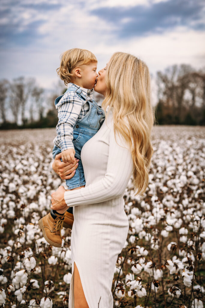 Mother embracing motherhood in a field of cotton in North Carolina captured by Family Photographer RattTrap Artistry 