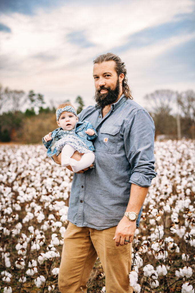 Dad and daughter in a field of cotton in North Carolina 