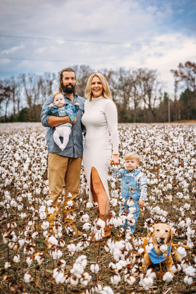 Family in a field of cotton with their dogs at family photo session in North Carolina 