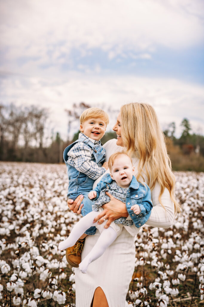 Mother embracing her children in a field of cotton at family session 