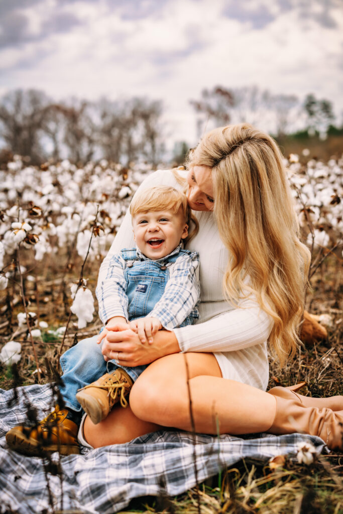 Mother and son in a field of cotton embracing the moment 