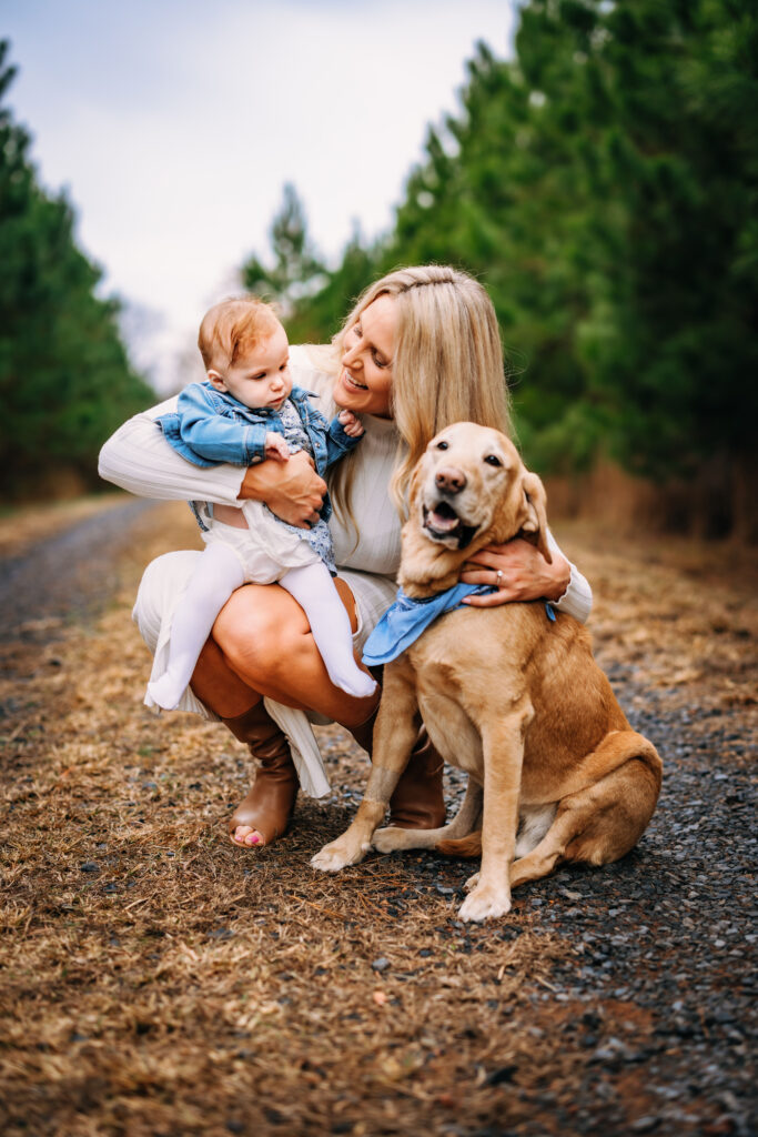 Mother and daughter loving on their dog at family session in North Carolina 