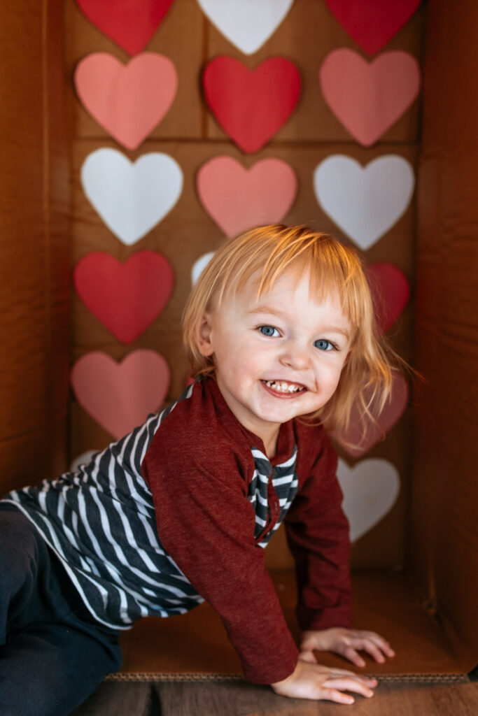 Toddler boy in a Cardboard box themed for valentine's Day Photos 